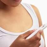 Woman holding pregnancy test