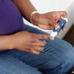 closeup-of-pregnant-african-american-woman-monitoring-her-blood-picture-id181869375