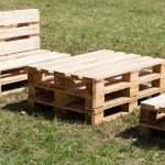 wooden-furniture-made-of-pallets-standing-on-the-grass-chair-table-picture-id991091362