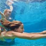 mother-baby-girl-swim-and-dive-underwater-in-pool-picture-id540205990