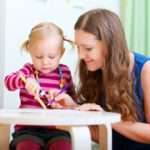 Mother drawing together with her daughter