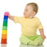 Small baby with toy pyramid isolated