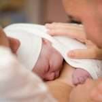 Newborn baby girl right after delivery, shallow focus