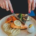 woman-eating-redfish-steak-and-mashed-potatoes-with-vegetables-picture-id1216450952