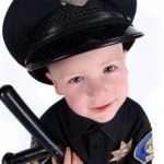 Funny Adorable Image of a Child Police Officer Holding a Night Stick