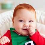 cute-happy-infant-baby-boy-in-elf-costume-sitting-in-highchair-picture-id922698874