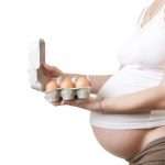 pregnant-woman-holding-eggs-studio-shot-picture-id910694712