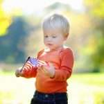 cute-toddler-boy-holding-american-flag-picture-id540212890