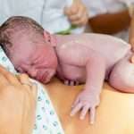 happy-mom-having-her-baby-skin-to-skin-first-seconds-after-birth-picture-id845976702