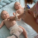 Babies enjoying playing with mother early in the morning